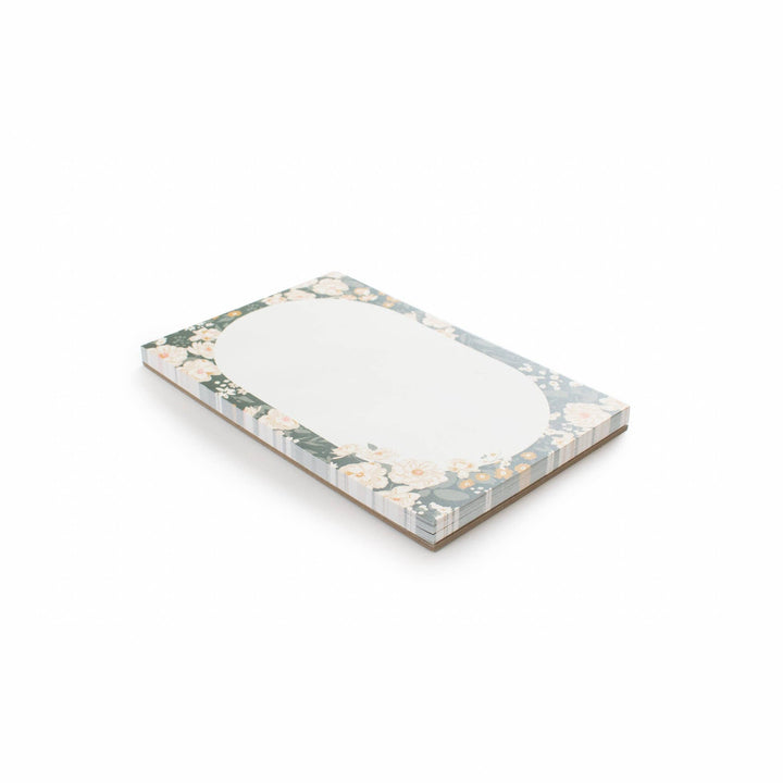 Floral-patterned notepad on a white background