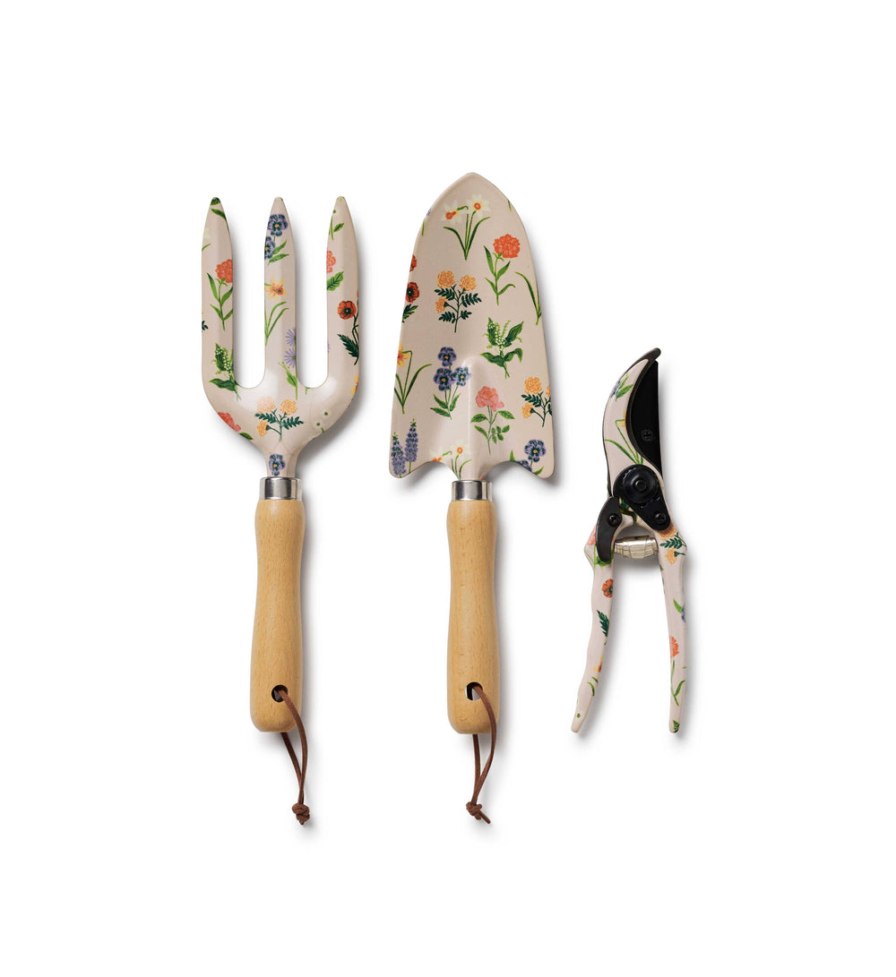 Set of three floral garden tools with wooden handles on a white background