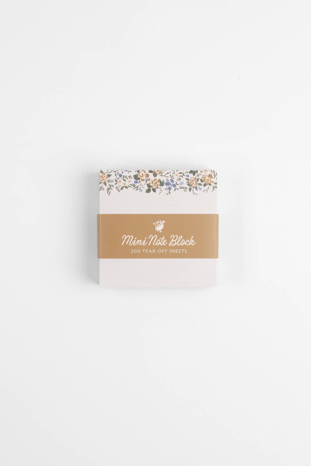 Note block with floral design on top and brand name on a white background