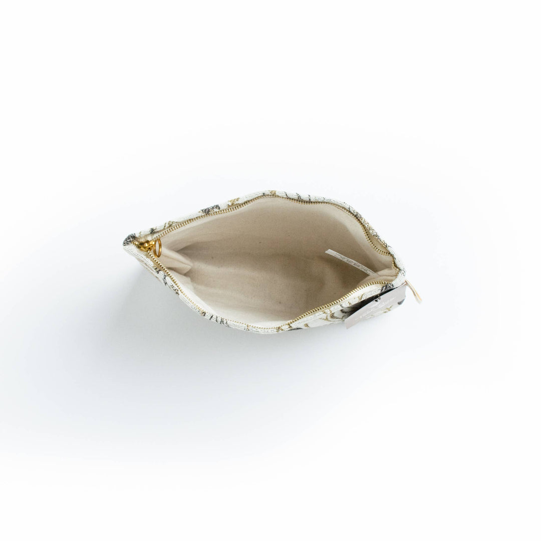 Open beige floral tool bag with gold trim on a white background