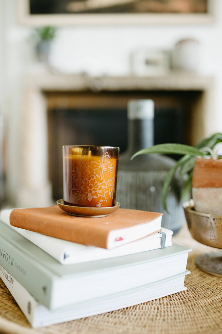 Candle on a stack of books with a blurred background