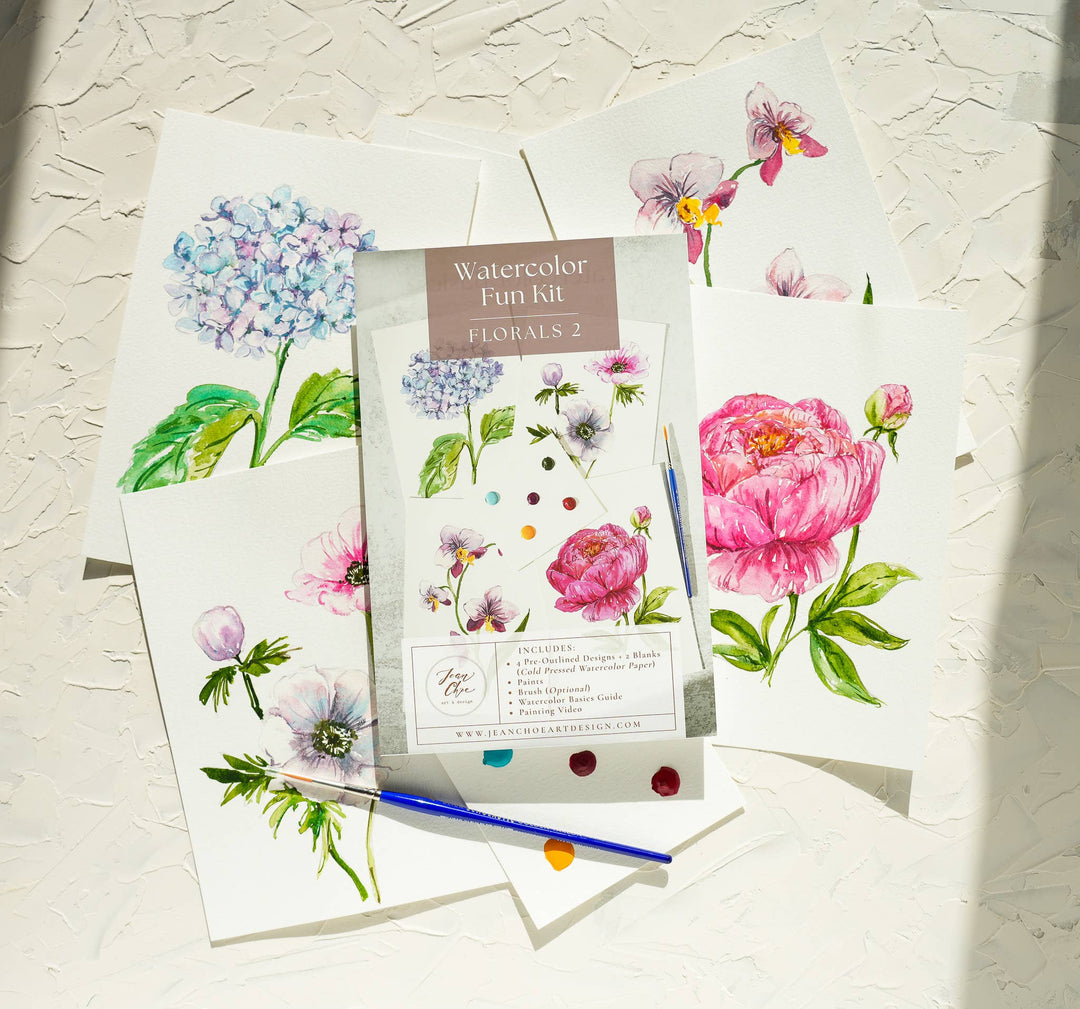 Watercolor fun kit with floral designs on a textured surface