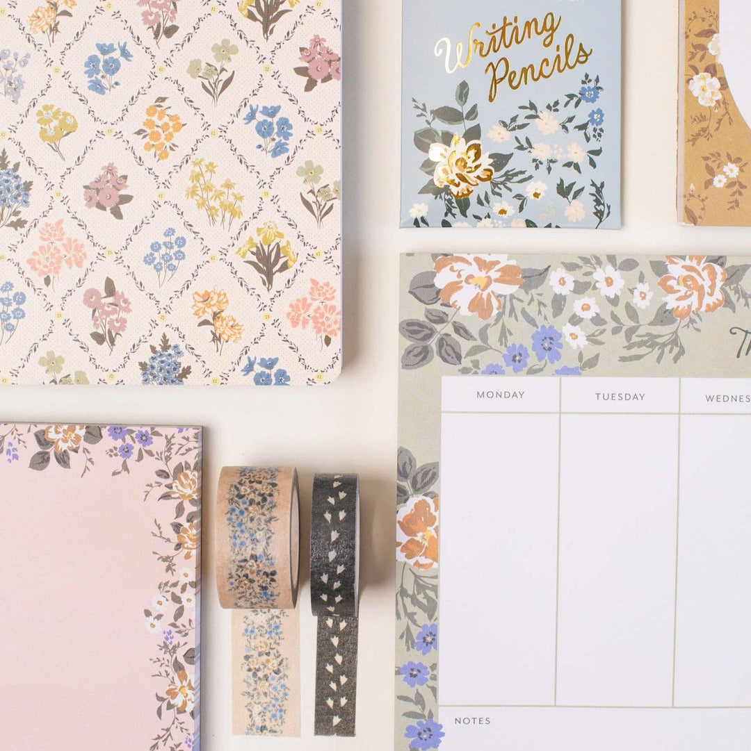 Stationery items with floral designs on a white background