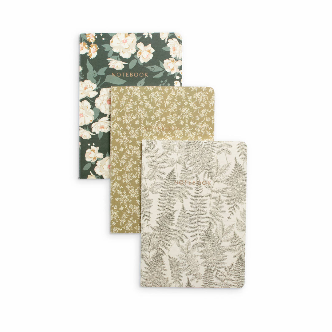 Three notebooks with floral and botanical covers on a white background