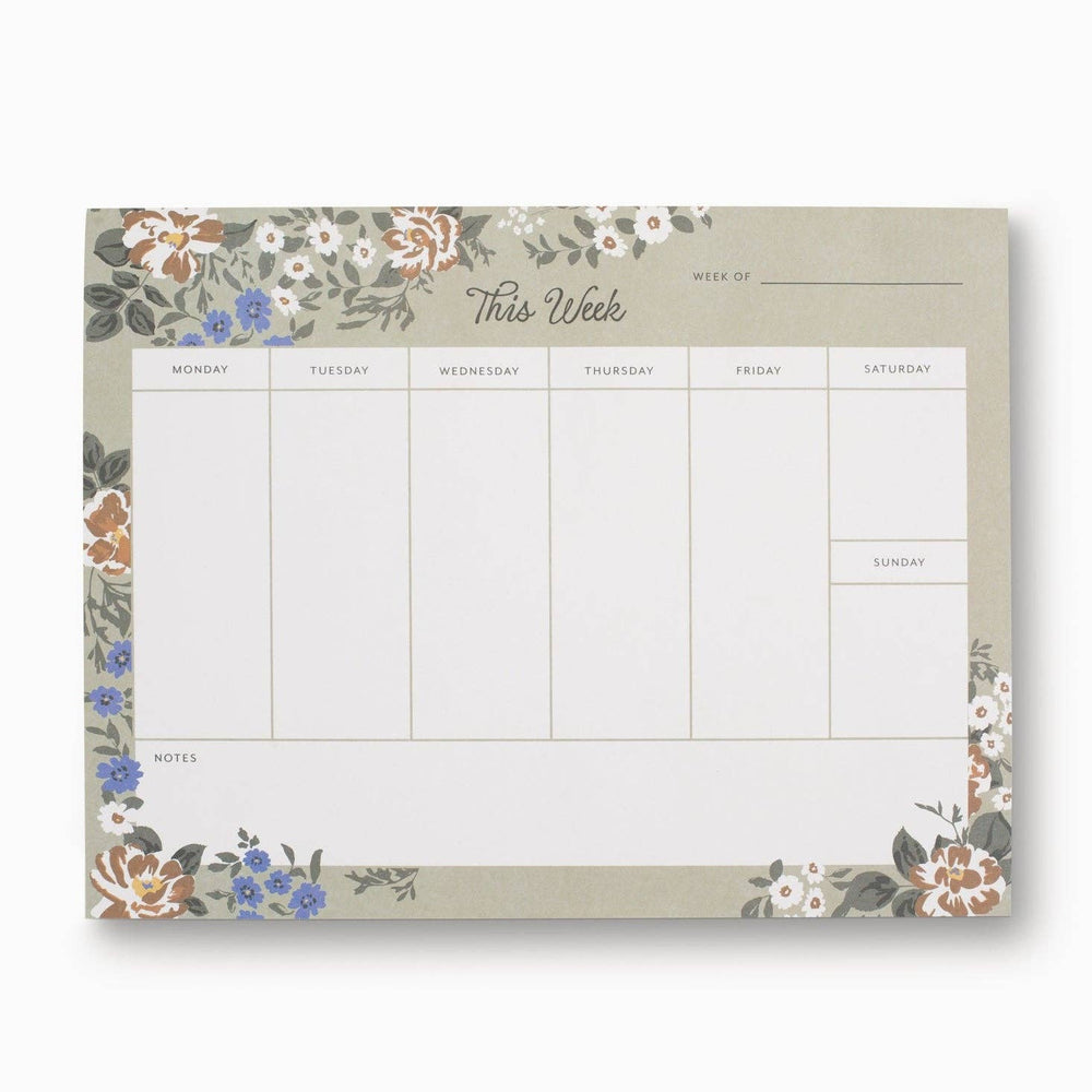 Weekly planner pad with floral design on a white background