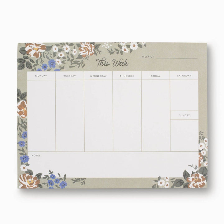 Weekly planner pad with floral design on a white background