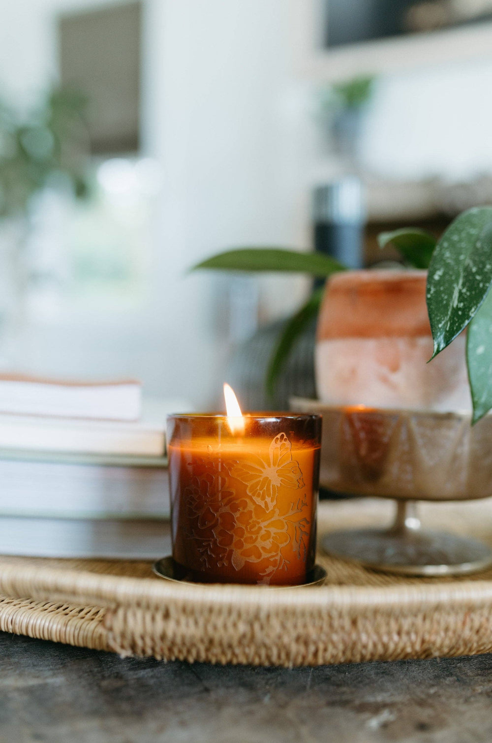 Candle in a decorative holder on a table with a blurred background