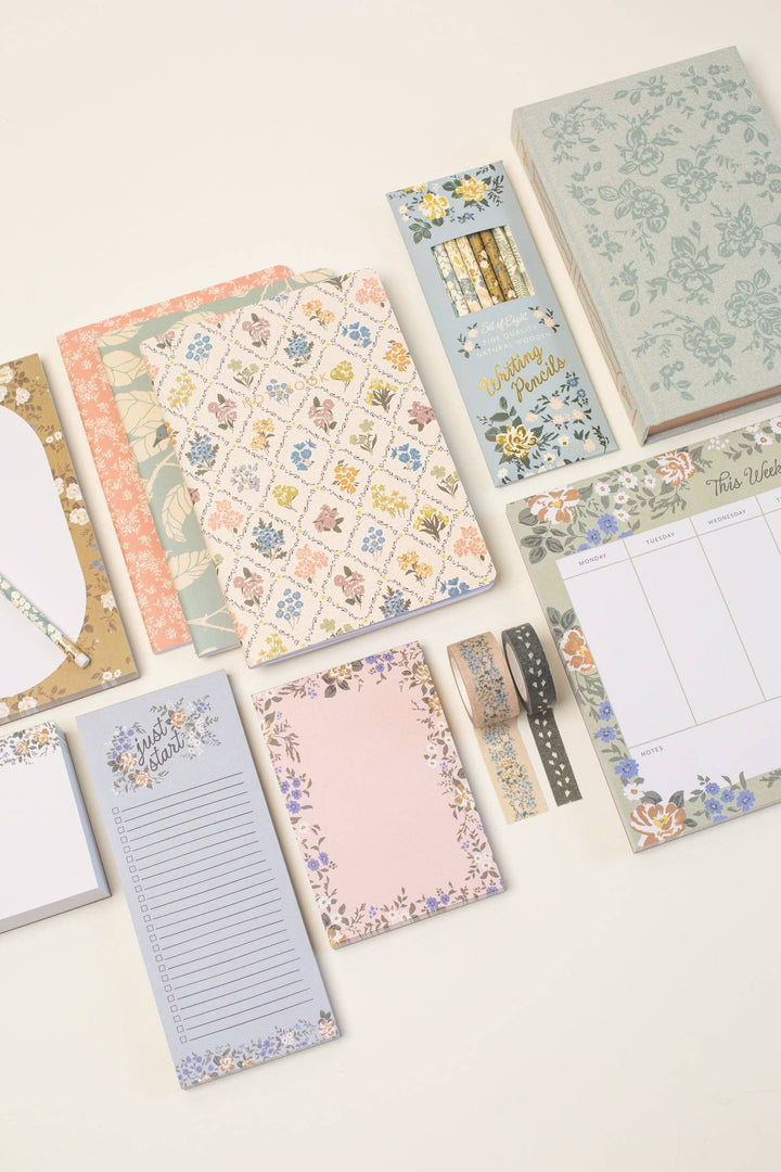 Collection of decorative notebooks and planners on a light background