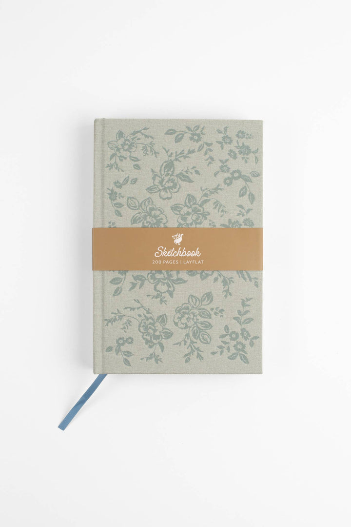 Floral-patterned notebook with a brown band on a white background