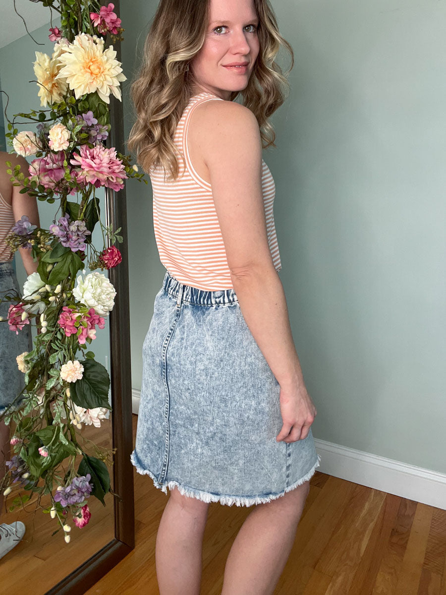 Light blue wash asymmetrical denim skirt with buttons