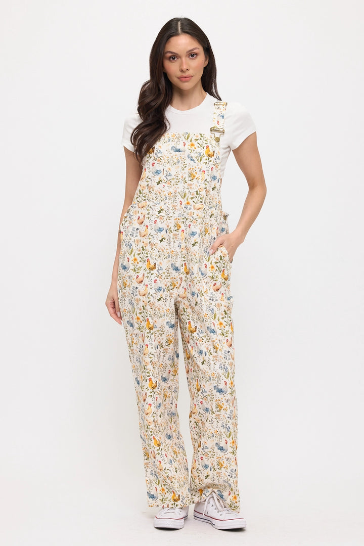 Woman wearing a chicken and flower patterned jumpsuit on a white background