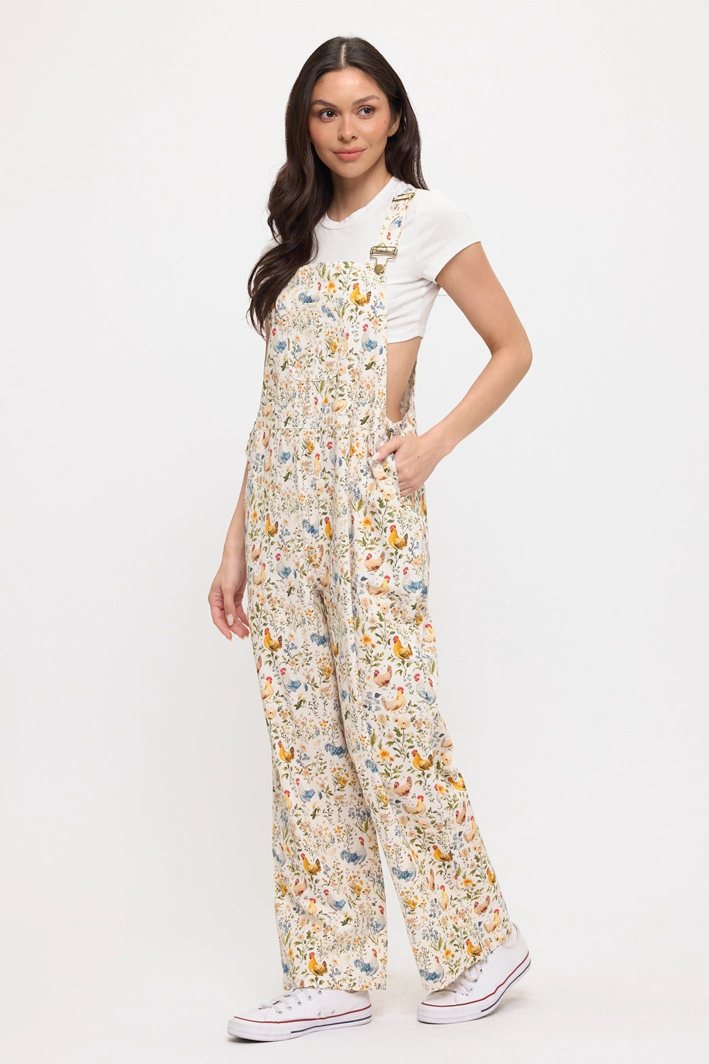 Woman wearing chicken and flower printed gardening overalls