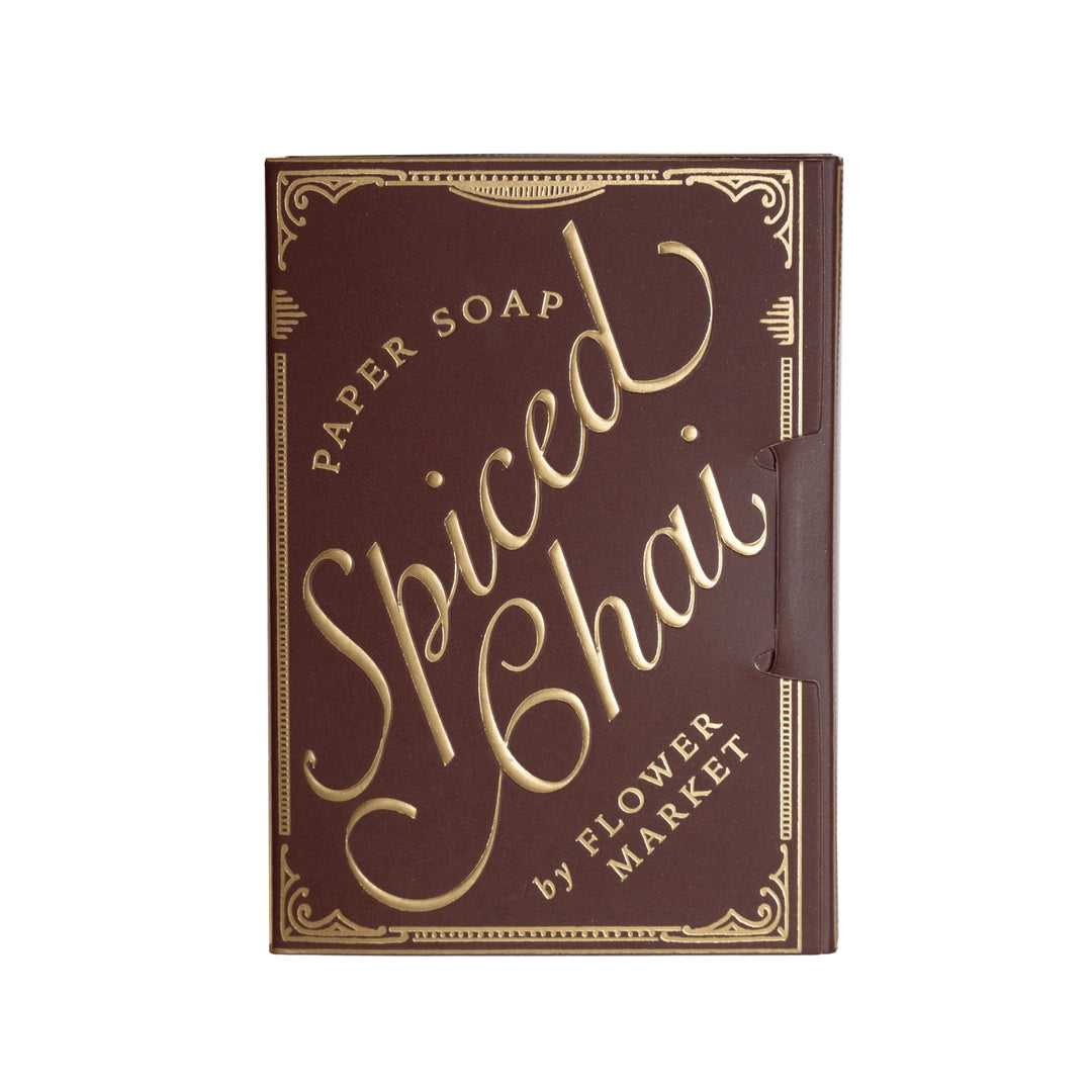 A rectangular paper soap box for 'Spiced Chai' by Flower Market, featuring a dark brown cover with elegant gold foil lettering and decorative borders, shown on a plain white background.