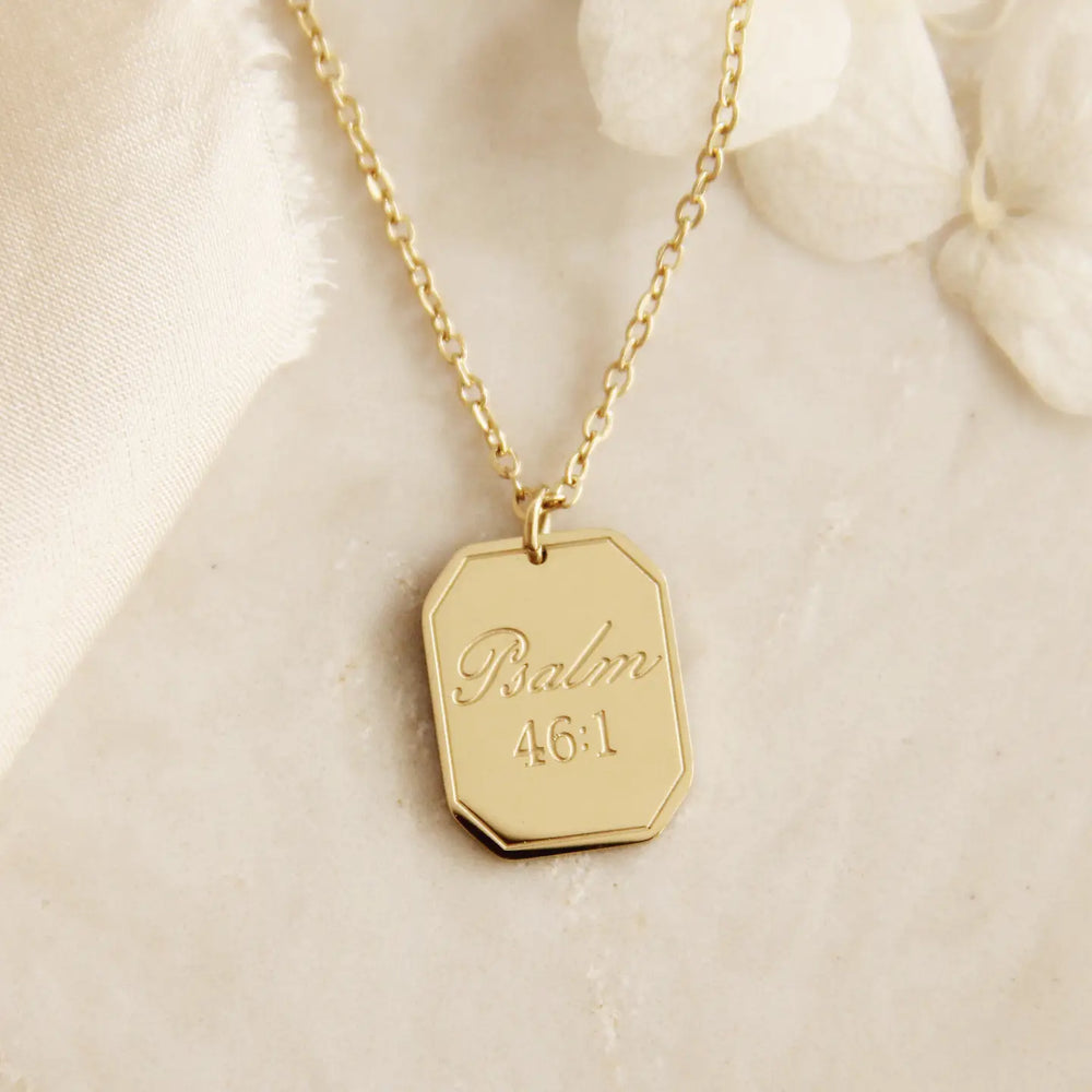 Gold Christian necklace with a hexagonal pendant engraved with Psalm 46:1
