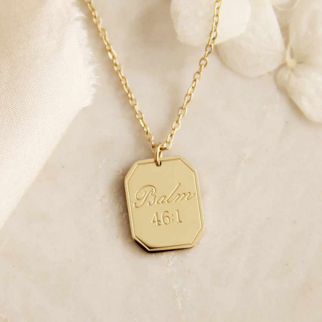 Gold Christian necklace with a hexagonal pendant engraved with Psalm 46:1