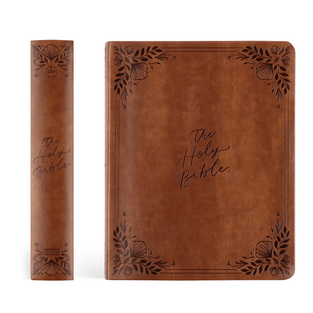 Brown leather-bound Bible with decorative embossing on a white background