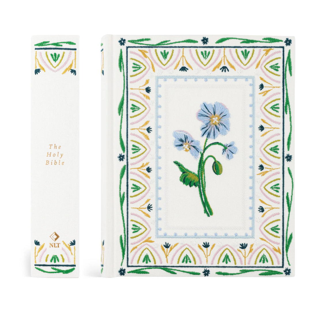 Floral embroidered Bible with intricate border on a white background