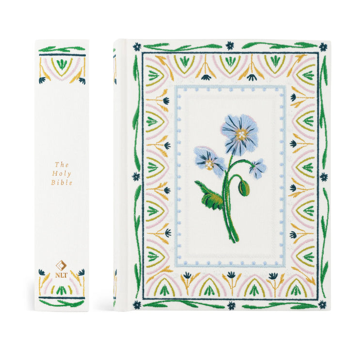 Floral embroidered Bible with intricate border on a white background