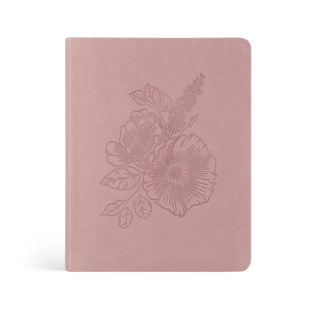 Pink Bible with floral embossing on a white background