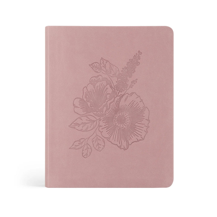 Pink Bible with floral embossing on a white background