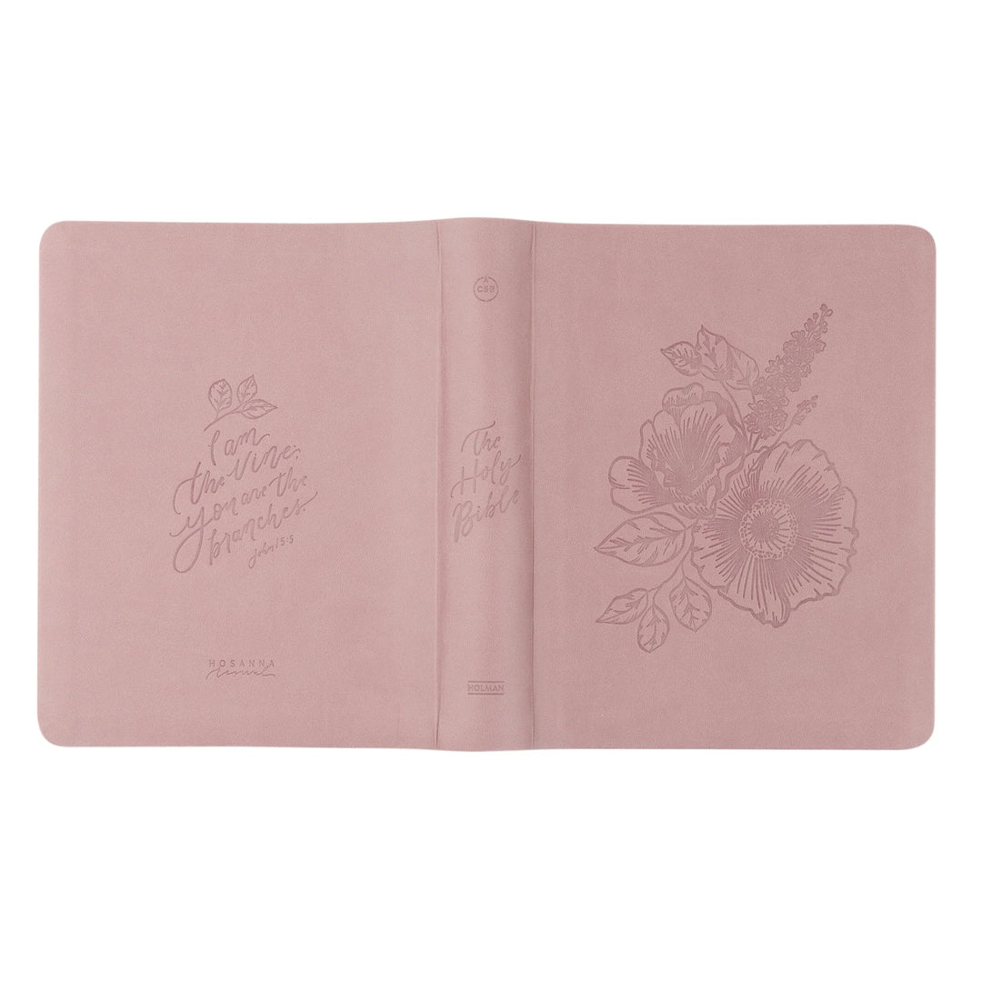 Pink Bible with floral embossing on a white background