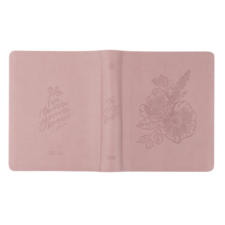 Pink Bible with floral embossing on a white background