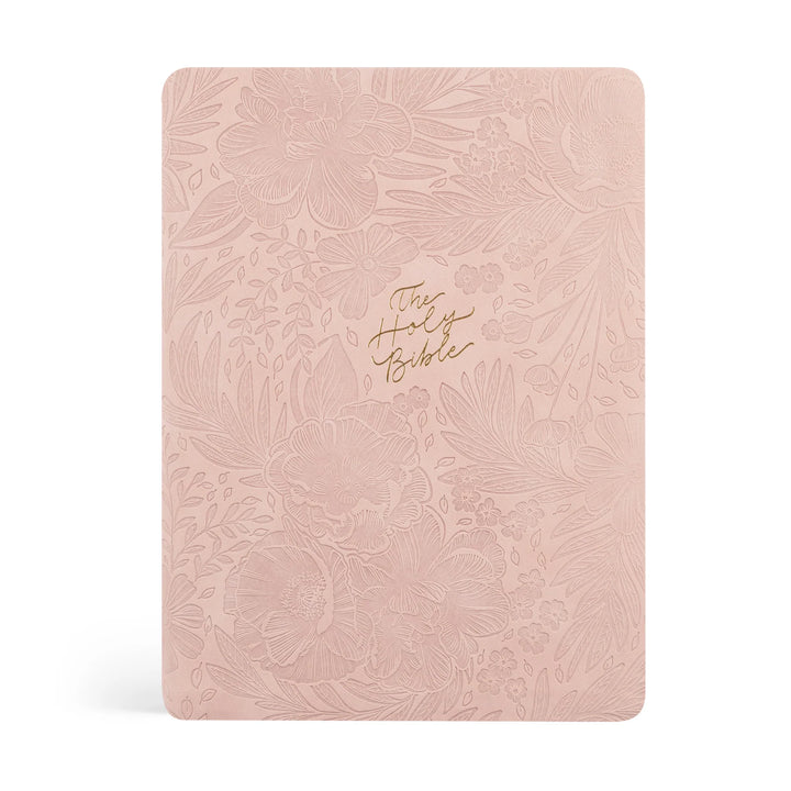 Pink floral-patterned Bible with gold text on a white background