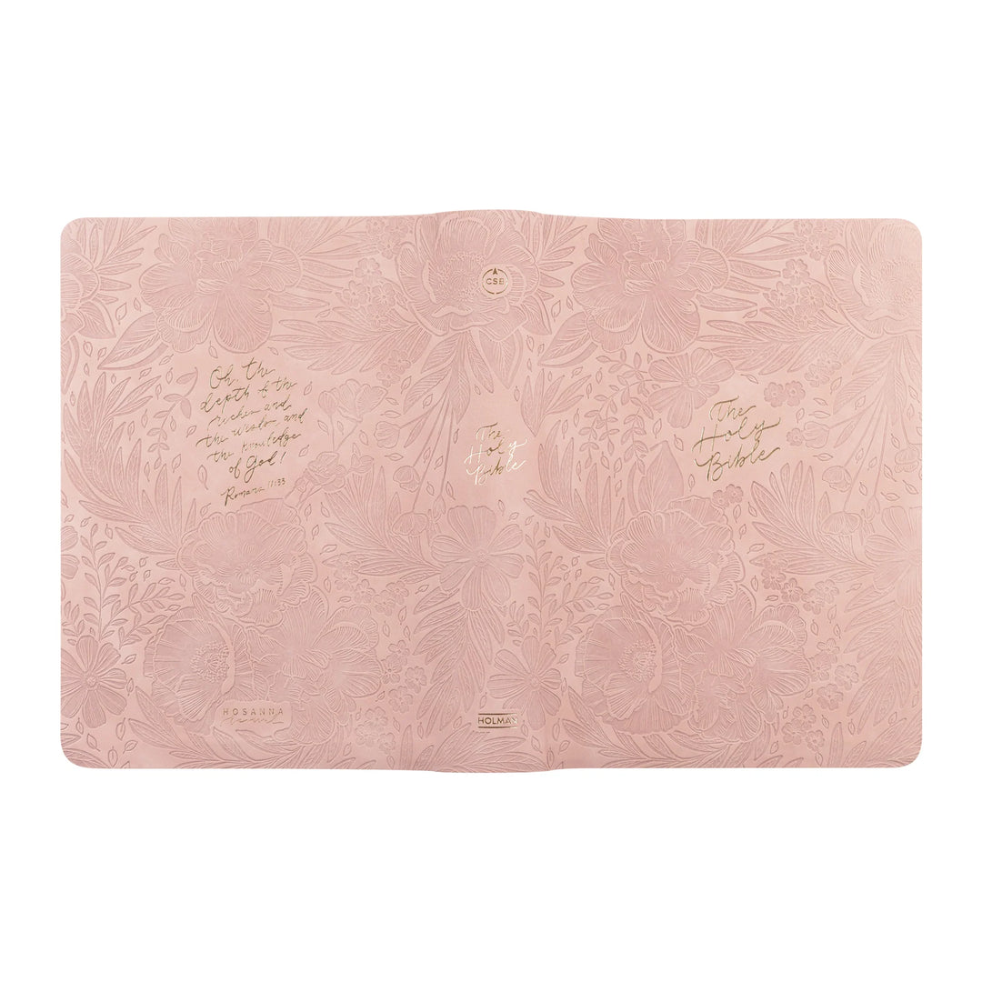Pink CSB Bible with embossed floral design and gold text on a white background