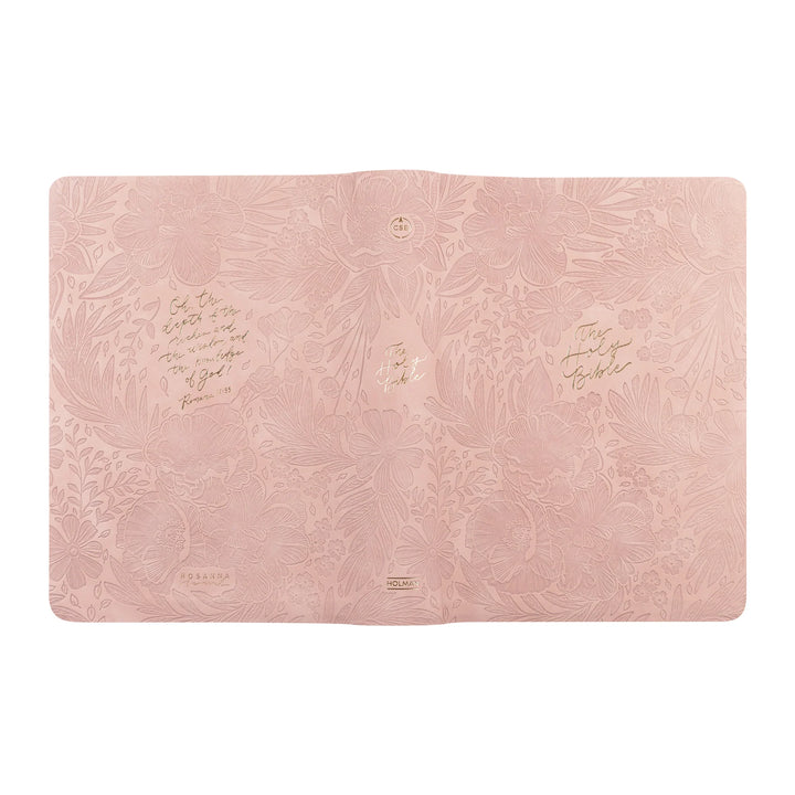 Pink CSB Bible with embossed floral design and gold text on a white background