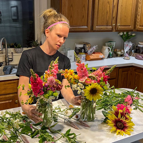 Emily Miller of Branch and Bloom Farms works on Mason Jar arrangements for the farmstand