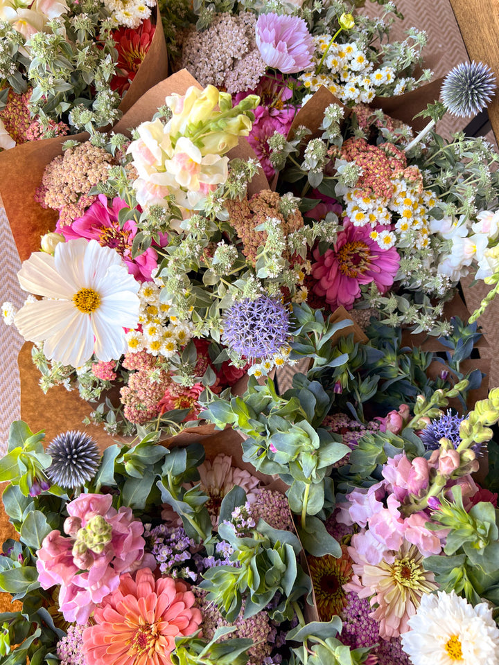 Market bouquets featuring a mix of white, pink, and purple flowers