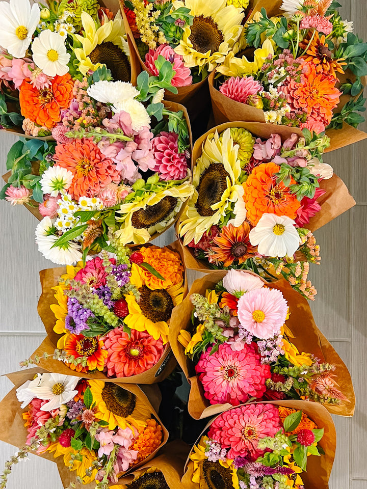 Colorful mixed market bouquets featuring sunflowers, zinnias and dahlias
