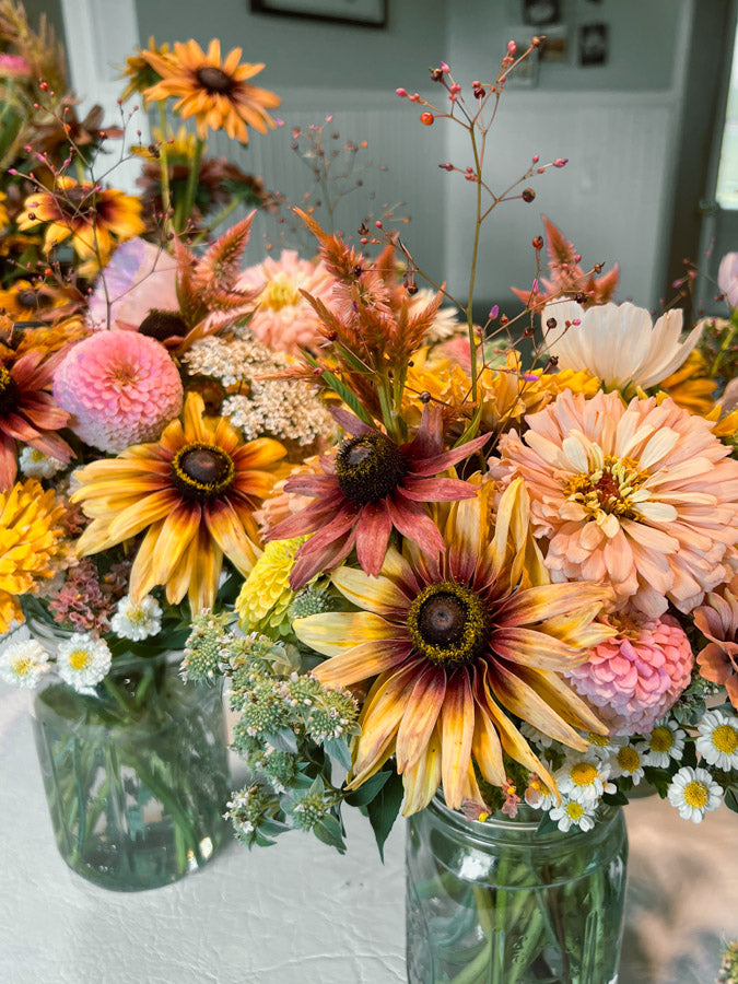 Custom mason jar arrangements filled with local flowers
