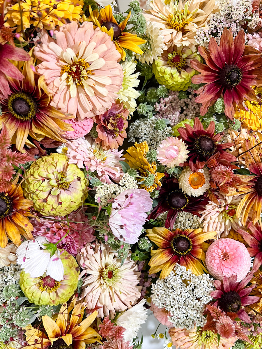 Colorful bouquet of various flowers including zinnias and black eyed susans