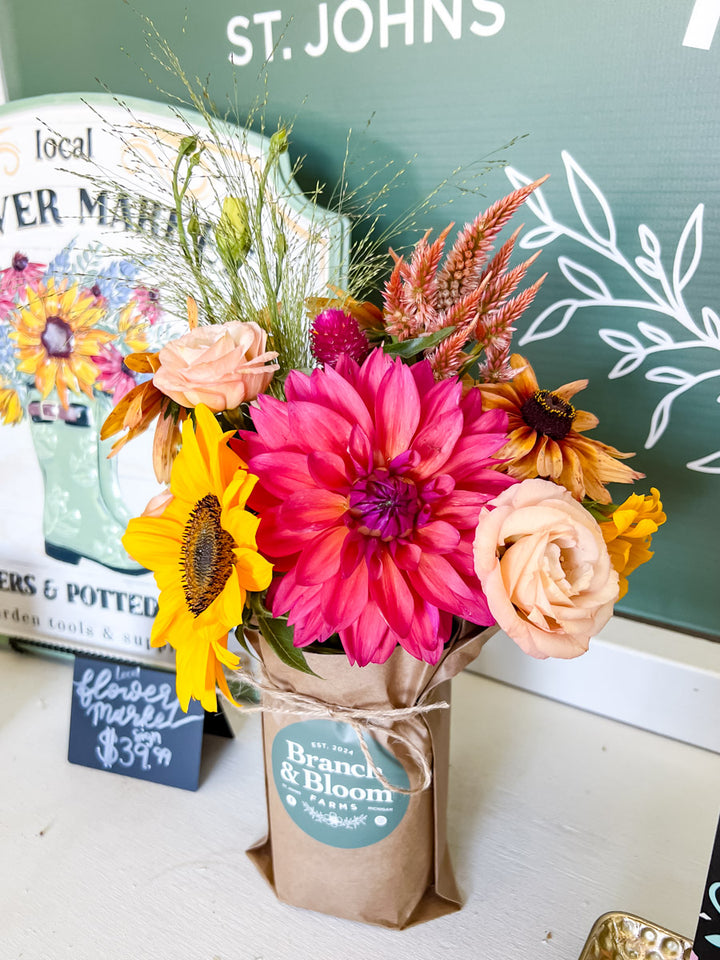 Bouquet of flowers in a wrapped Mason Jar Arrangement with 'Branch & Bloom Farms' branding