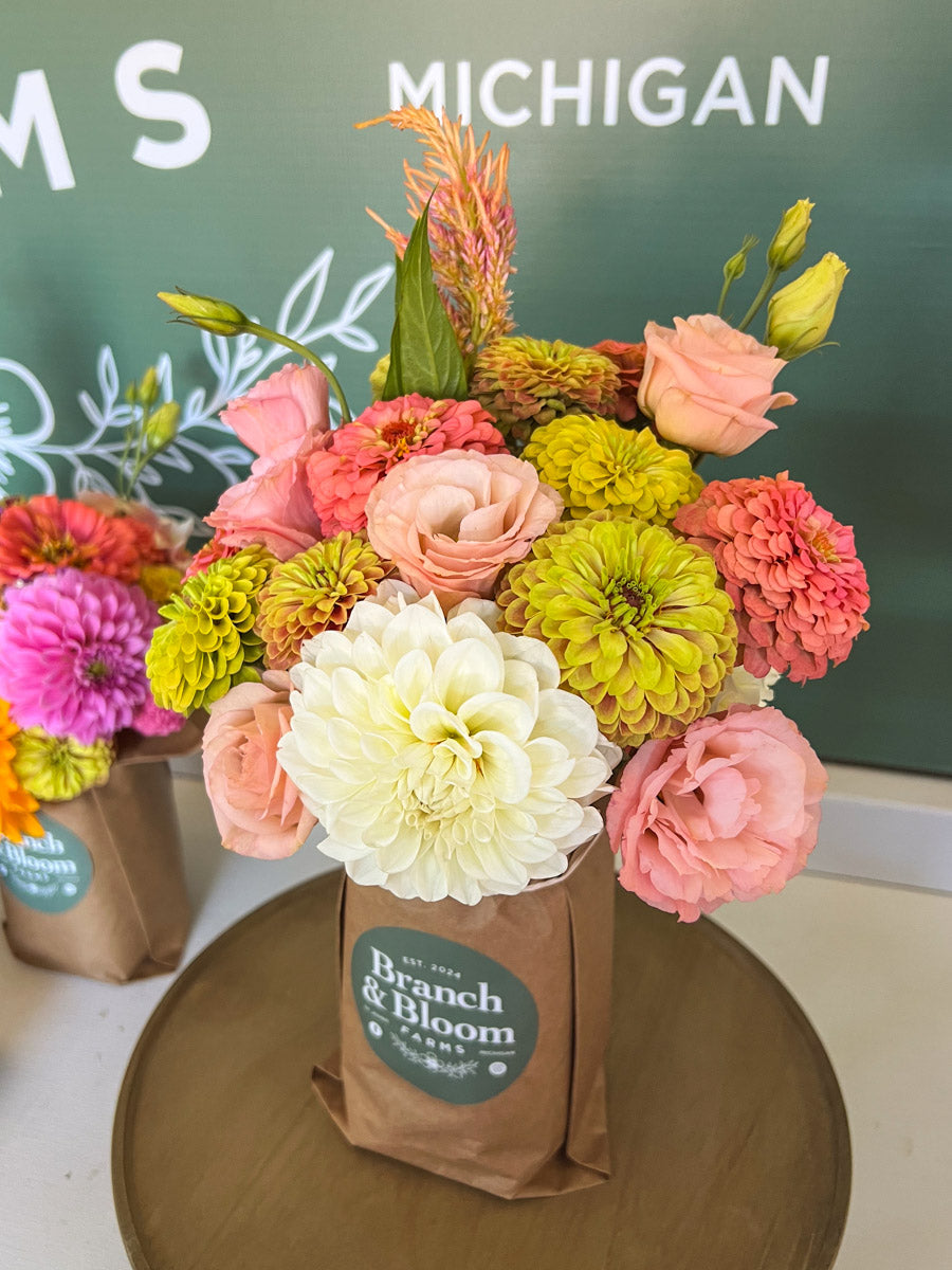Mason Jar Bouquet of flowers with 'Branch & Bloom Farms' branding in farmstand