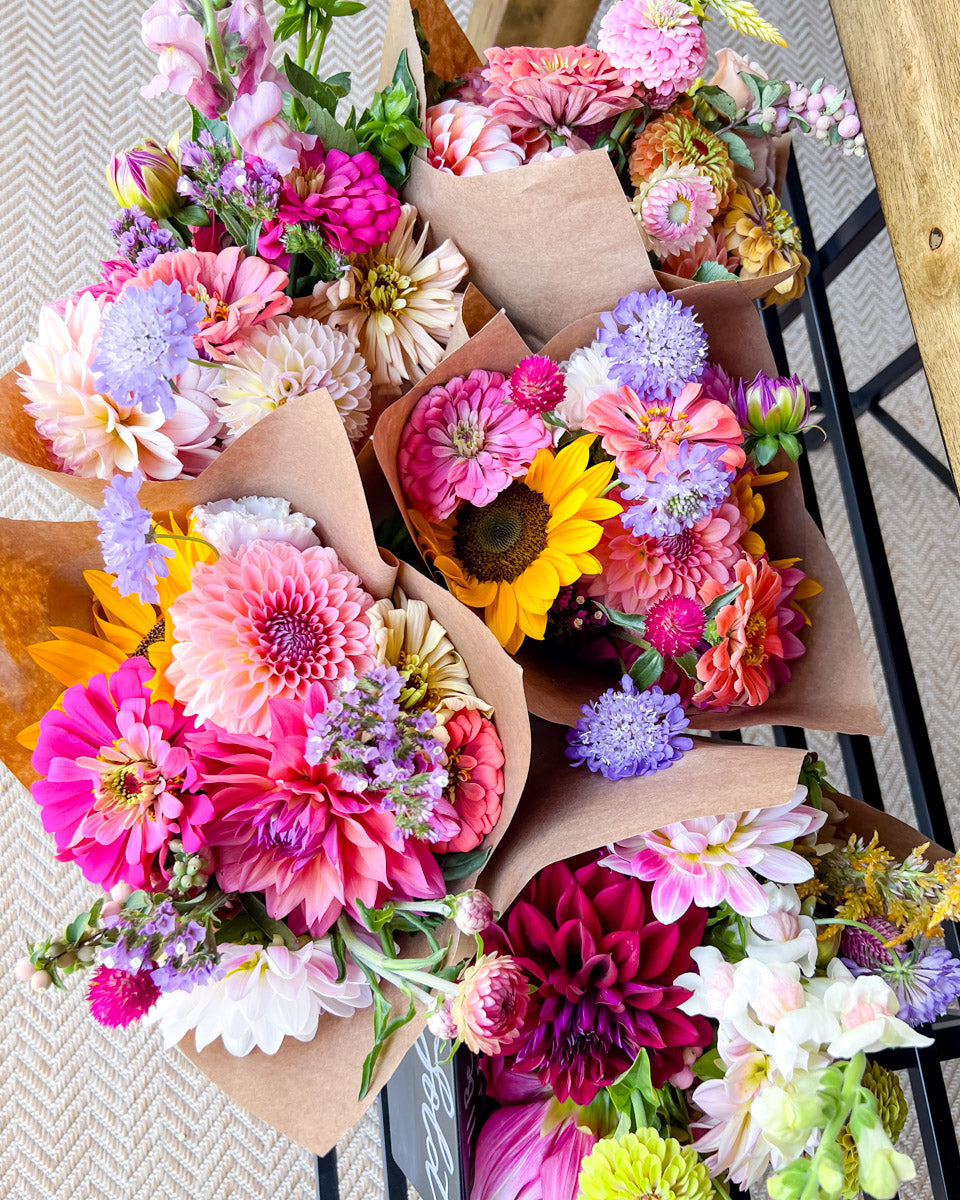 Colorful mixed market bouquets on display inside a farmstand