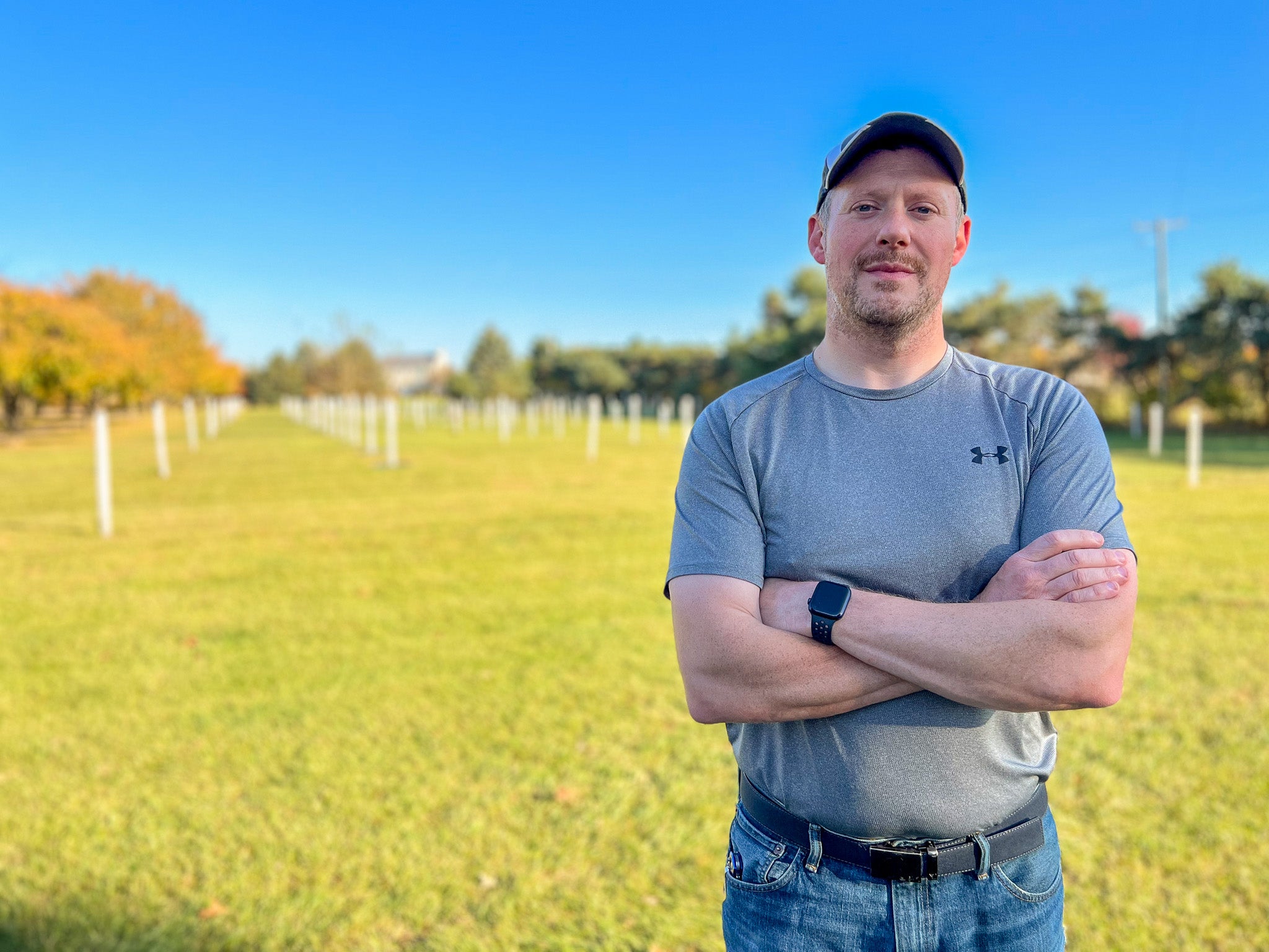 Jason Miller of Branch and Bloom Farms stands in front of his newly planted chestnut orchard in St. Johns, MI