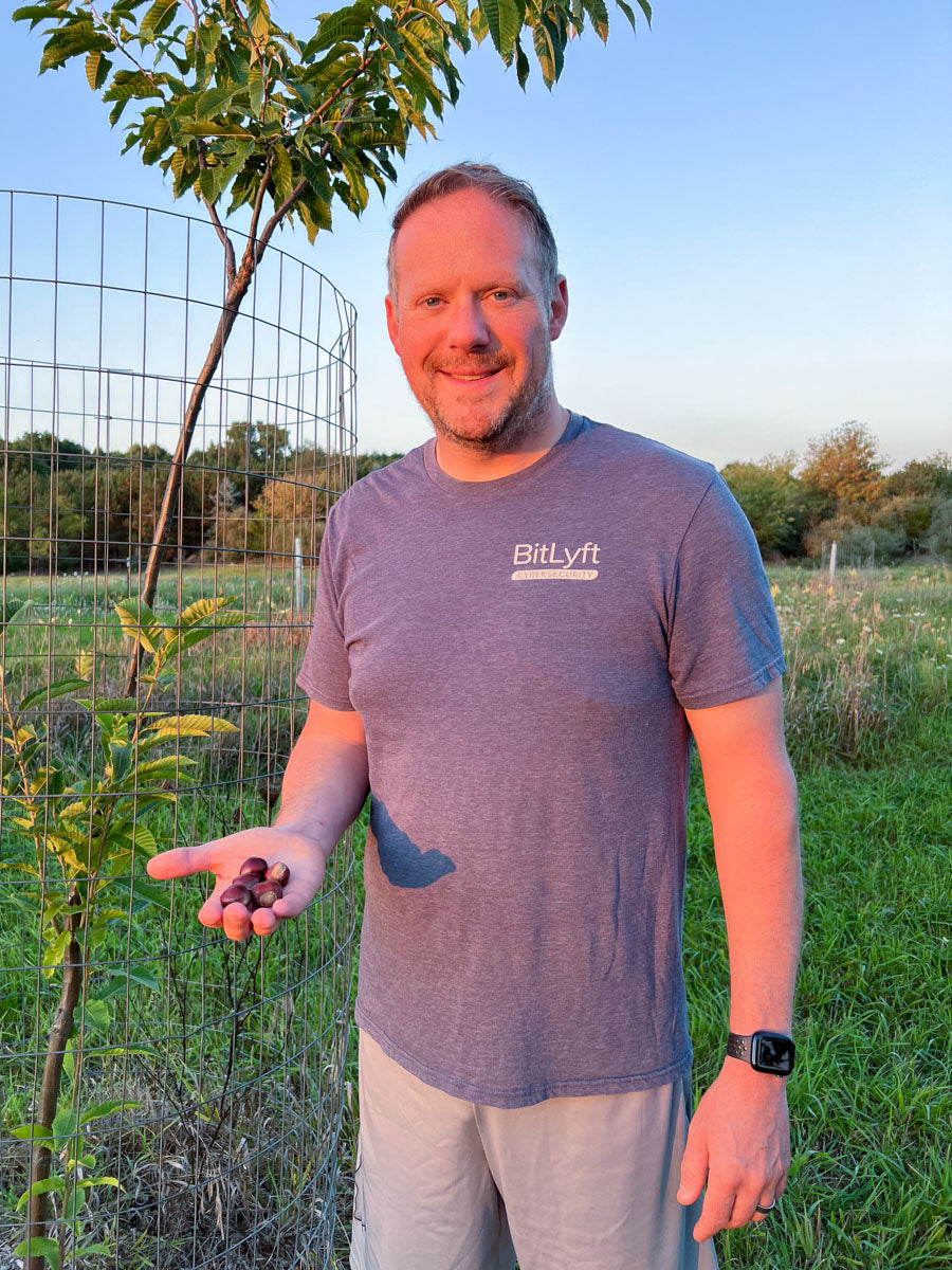 Jason Miller holding chestnuts at Branch and Bloom Farms in St. Johns, MI