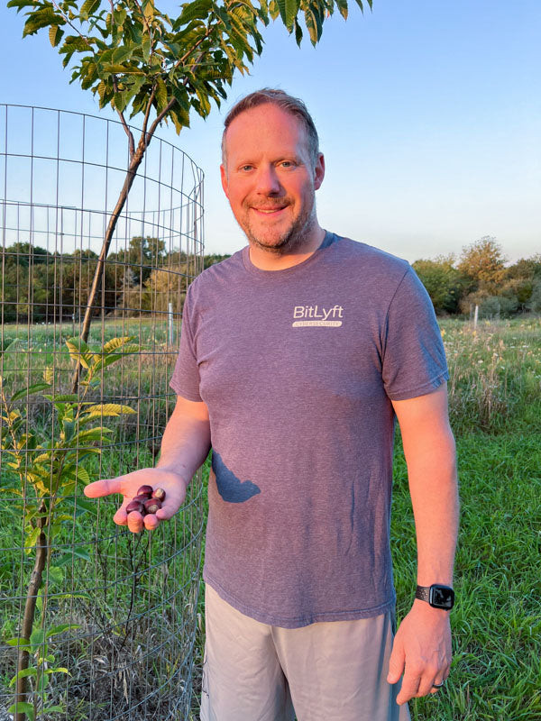 Jason Miller holds chestnuts from one of his trees