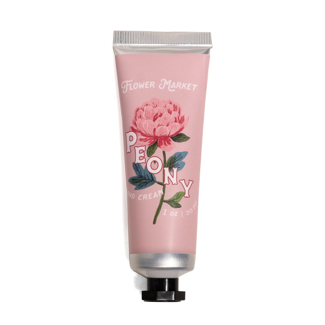 Travel size peony hand cream tube with pink packaging and floral design on a white background