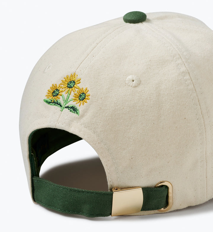 Beige cap with embroidered sunflowers on a white background