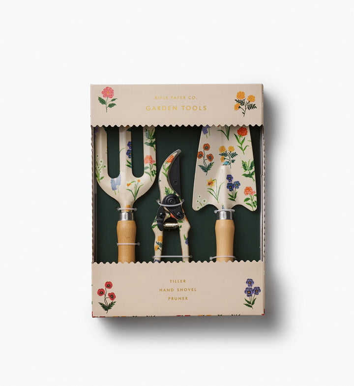 Set of garden tools with decorative handles in a box packaging on a white background