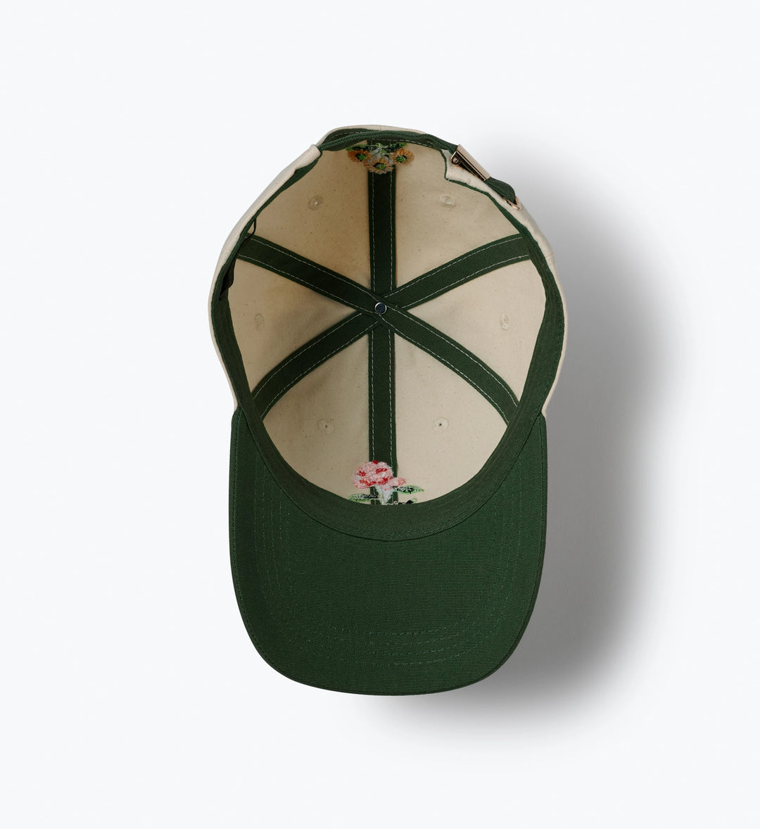 Green baseball cap with floral design on the back against a white background