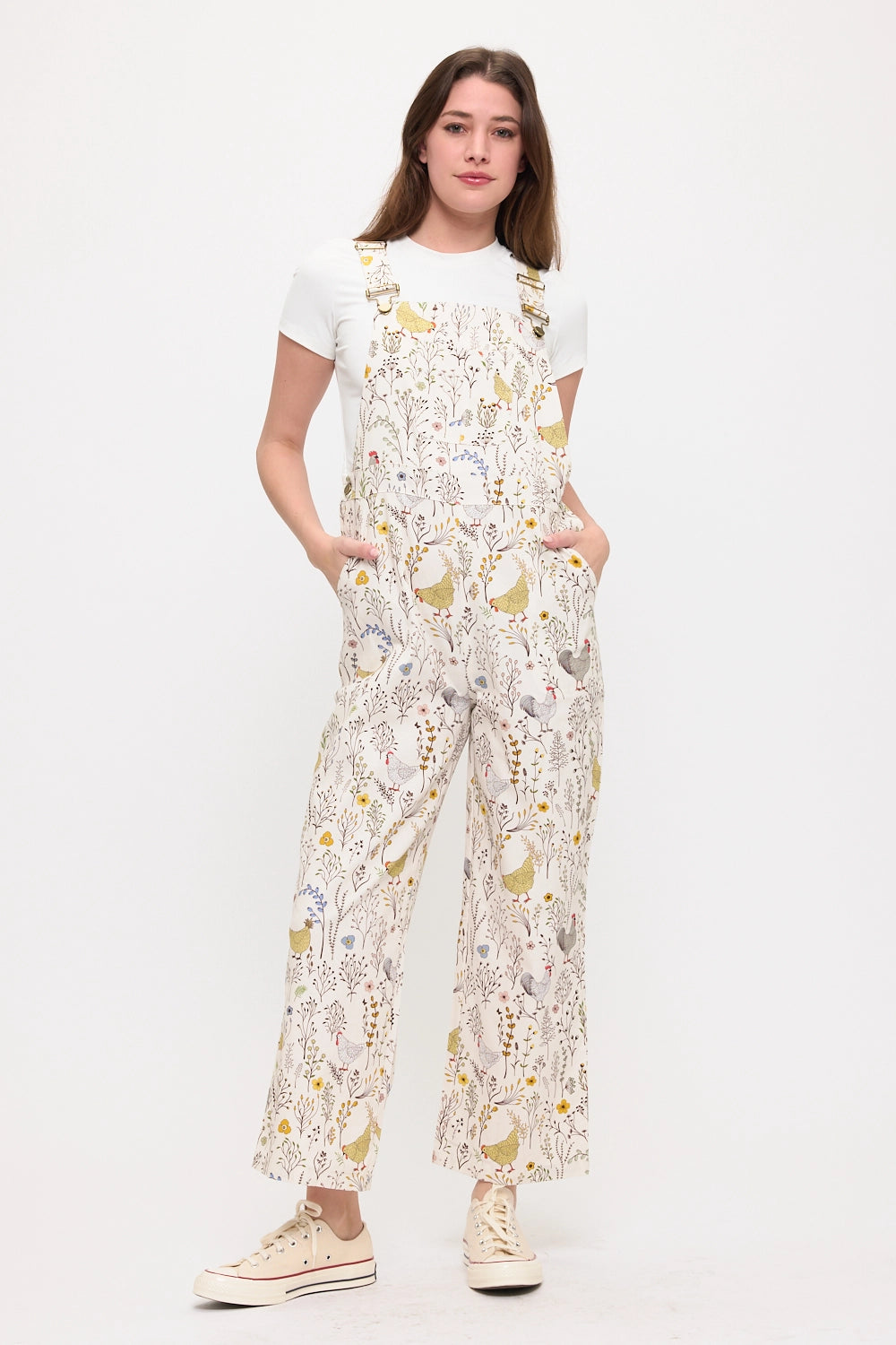 Woman wearing long chicken and botanical printed overalls