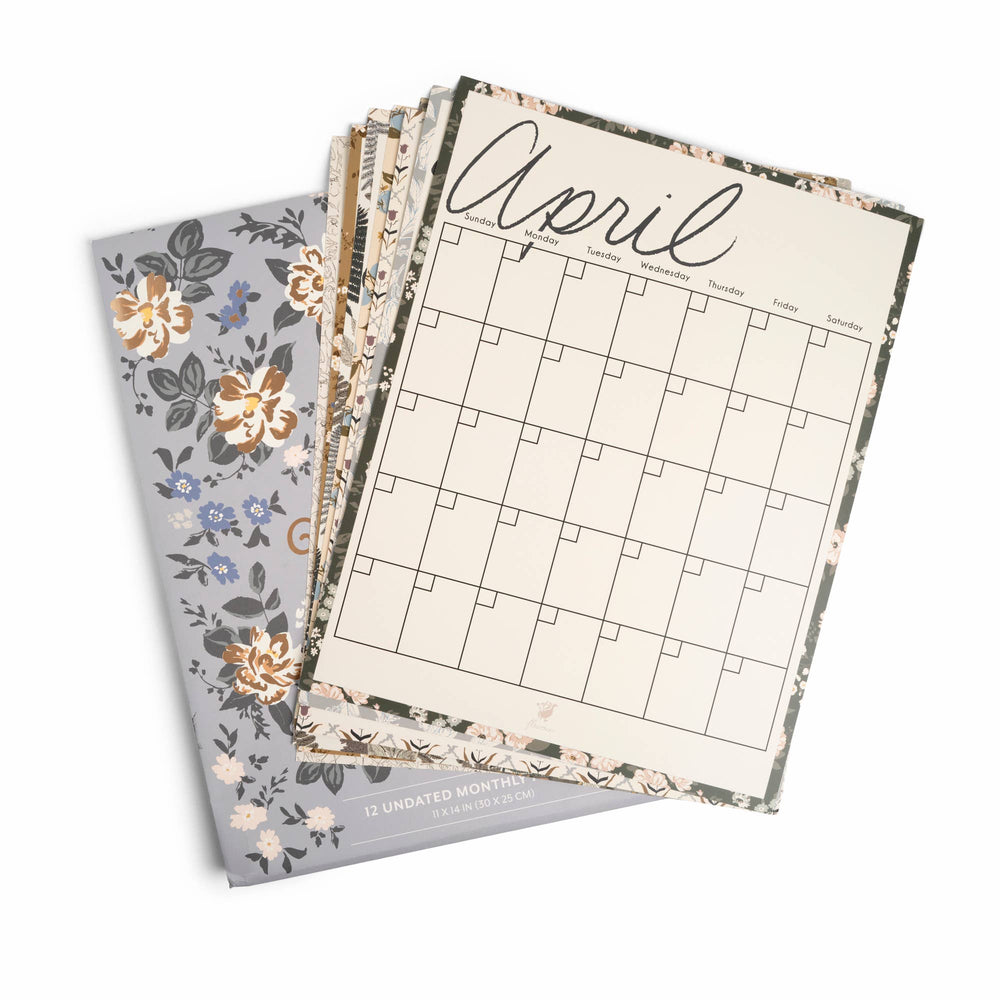 Set of three planners with floral designs and a calendar page on a white background