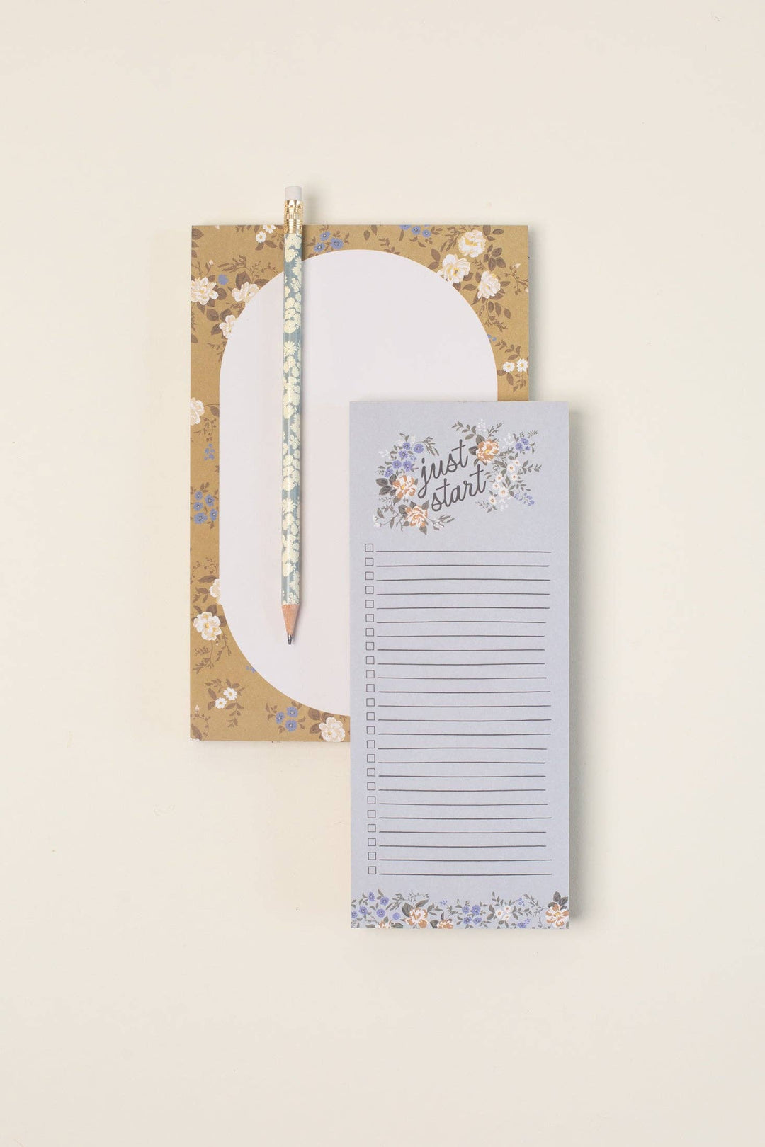 Floral notebook with a pencil on a beige background