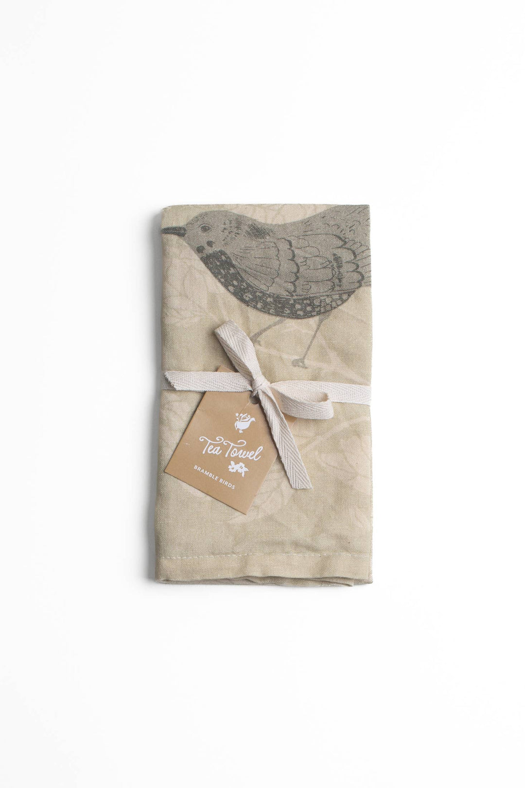 Textured beige linen tea towel with bird design and tag on a white background