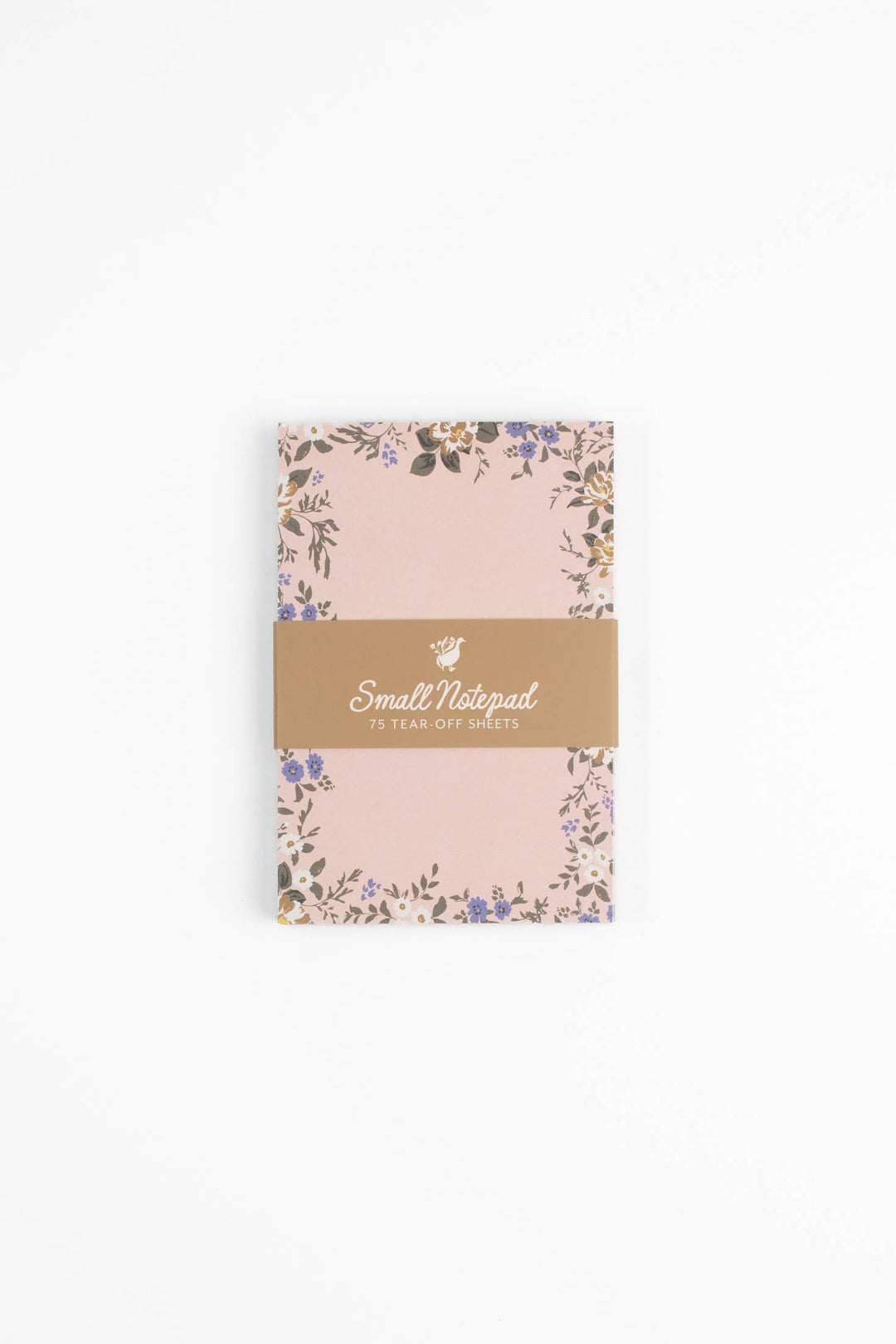Small pink notebook with floral design and gold label on a white background