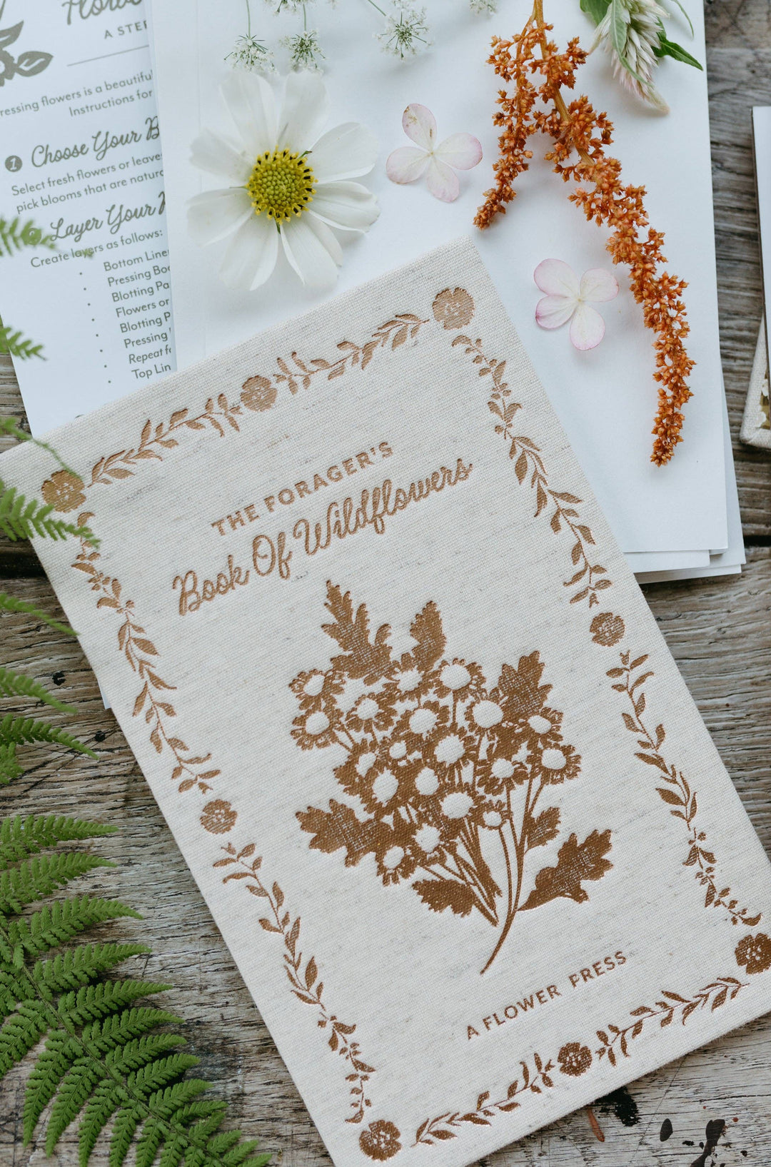 Book of Wildflowers with floral design on a wooden surface